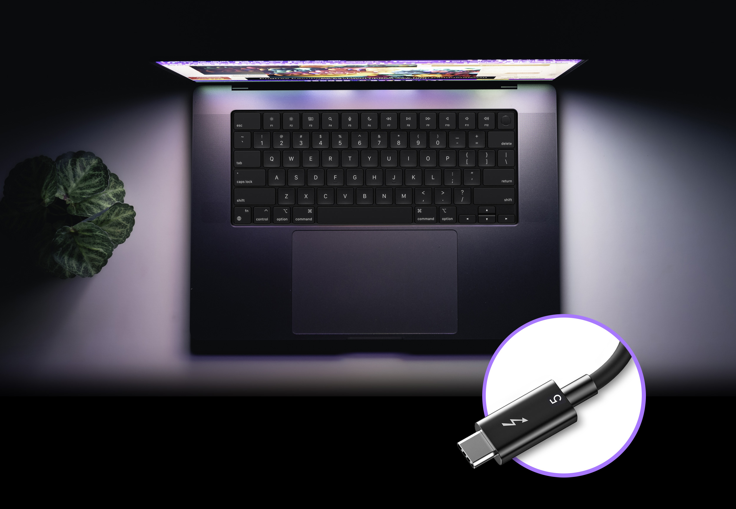 Overview shot of Apple M series MacBook Pro computer with a Thunderbolt 5 cable show next to it.