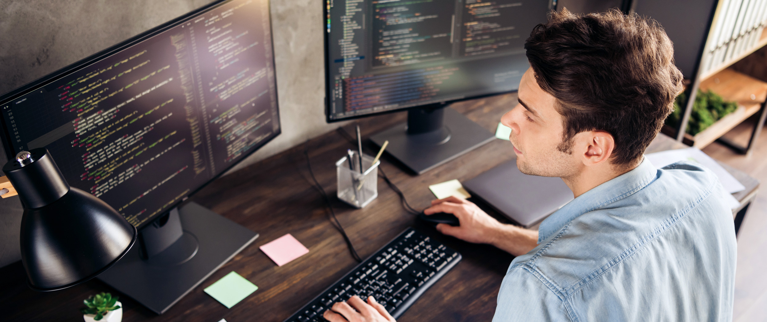 Man Working Behind Two 4K Monitors